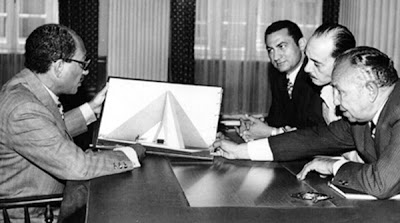 Sadat examines with Osman a design of the 6 October Panorama