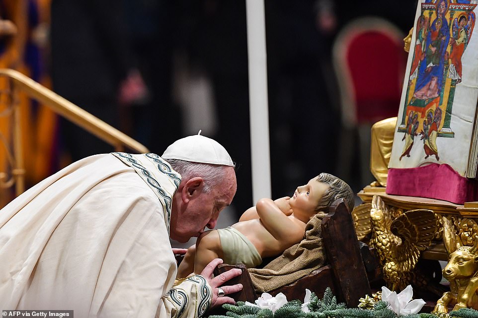 22850028-7841059-Pope_Francis_kisses_a_statue_of_the_baby_Jesus_Christ_during_the-a-1_1577839004183
