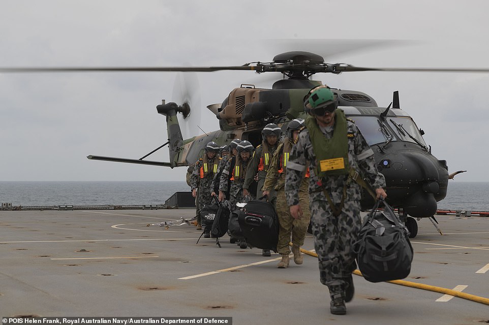 22893520-7844519-HMAS_Choules_enhanced_medical_team_pictured_disembarks_a_MRH_90_-a-104_1577974136488